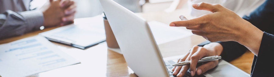 Closeup of a laptop and some document on table